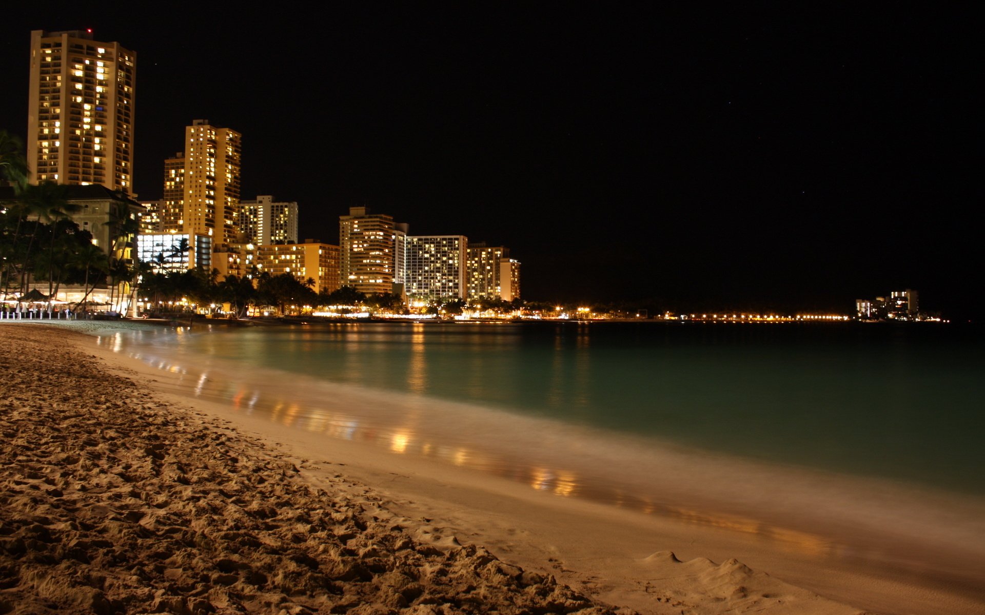 beach city skyscrapers in the night the evening lights silence skyscrapers light sea water coast sand trees city night the lights of the city
