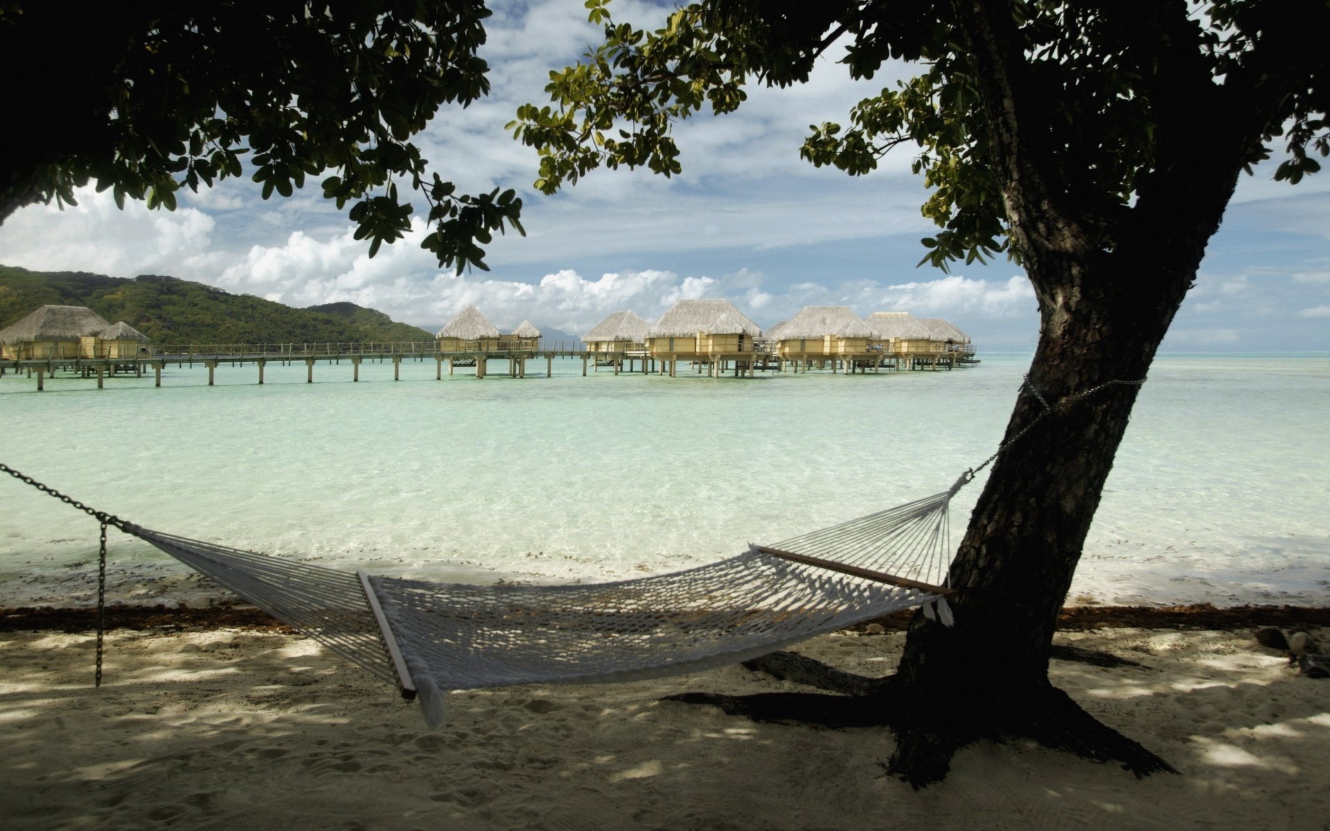 in the shade hammock summer water water sky sand shore sea tropics rest clouds coast beach