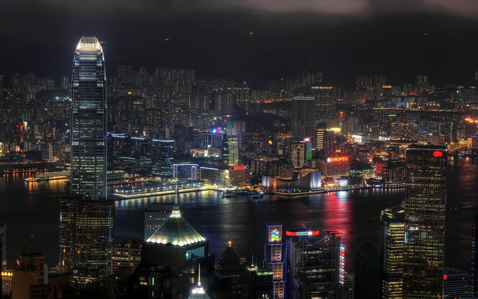 the view from the top panorama night city the lights in the windows building river night water city skyscrapers the lights of the city. usa america view reflection surface colored lights big city lights over water darkness beauty megapoli