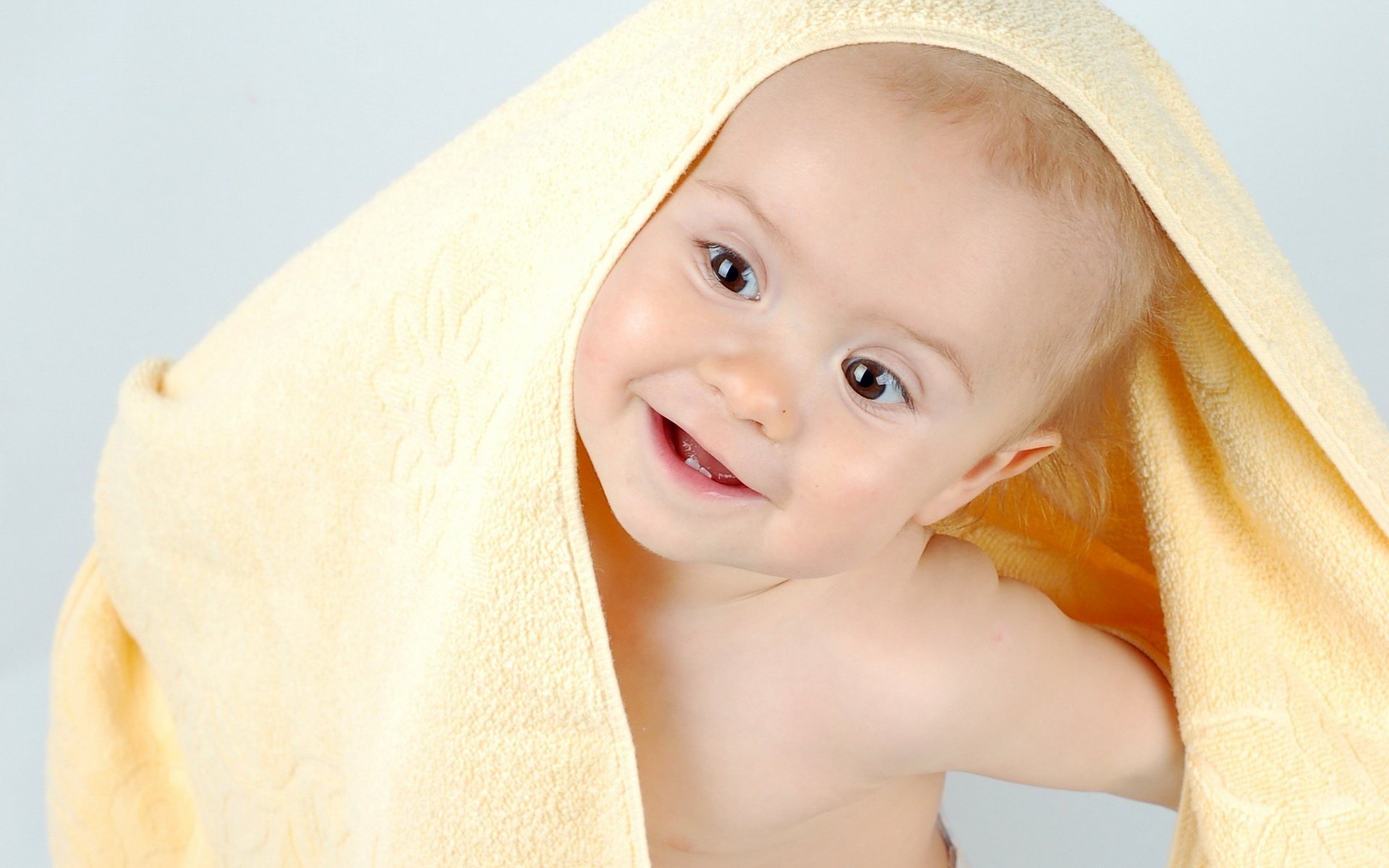 a view from under the towel and here i am boy portrait look smile eyes face