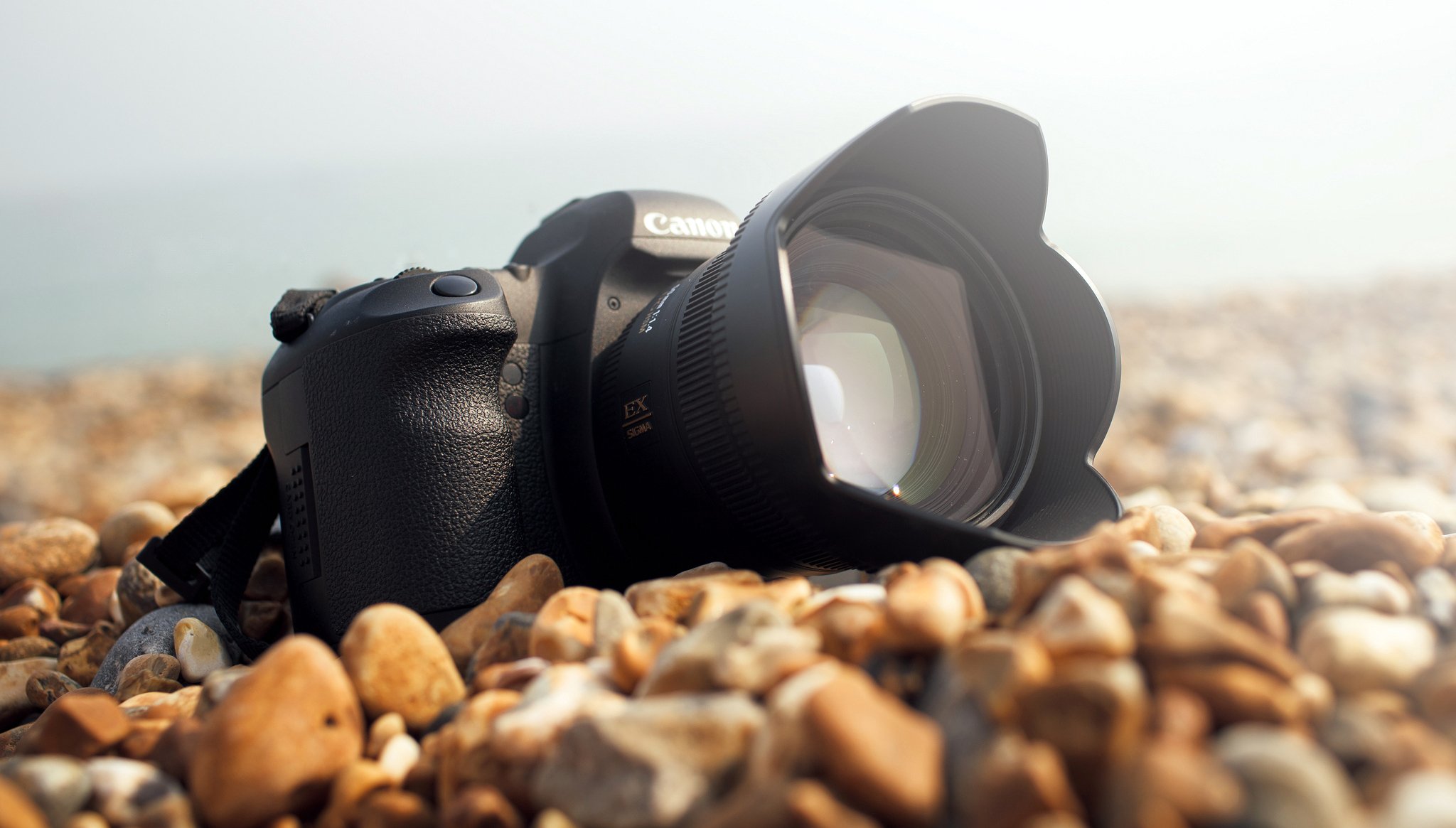 kamera canon objektiv steine küste meer sonniger tag