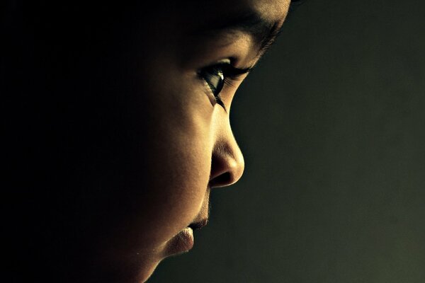 A beautiful baby with dark skin and a snub nose