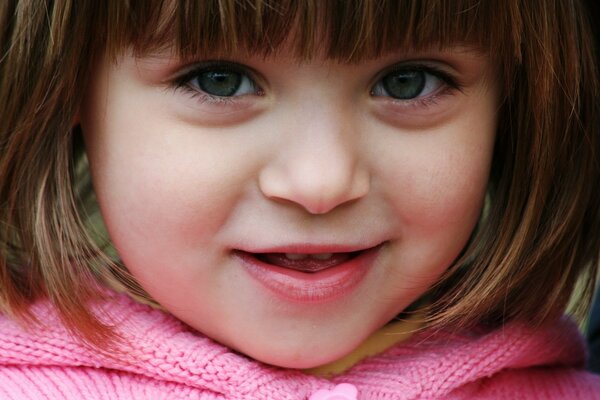 A girl s face with a half smile and loose hair