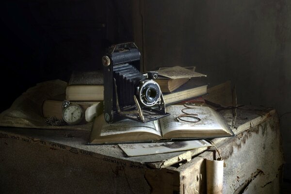 An old camera on an old book in the dust