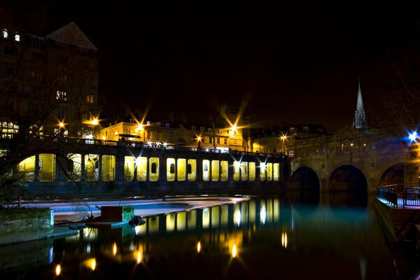 La luce notturna della città si riflette nel fiume