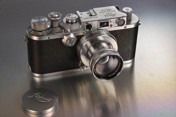 A camera with a retractable lens and a removable cover