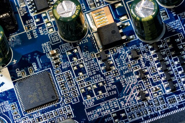 Blue board with white silk-screen printing and radio components close-up