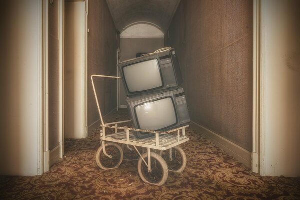 Retro TVs in a retro cart in an old room