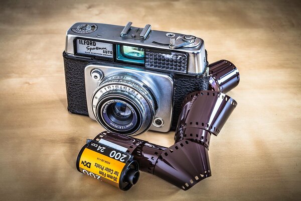 The camera with the tape lies on a wooden table