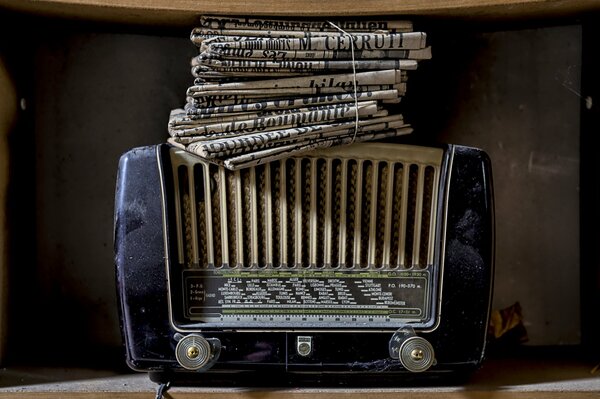A stack of bound newspapers in an old radio receiver