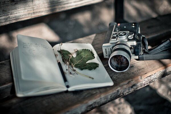 Retro camera on the bench next to the diary