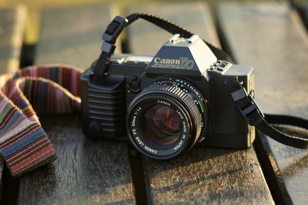 Vintage camera with multicolored strap