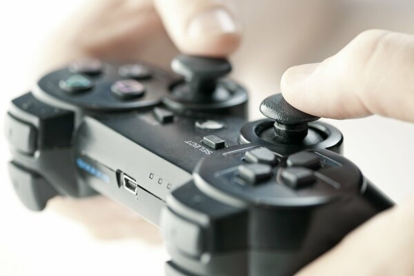 The gamer is sitting with his fingers on the controller