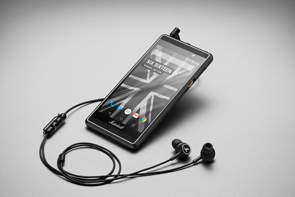 Smartphone with headphones, on the wallpaper London