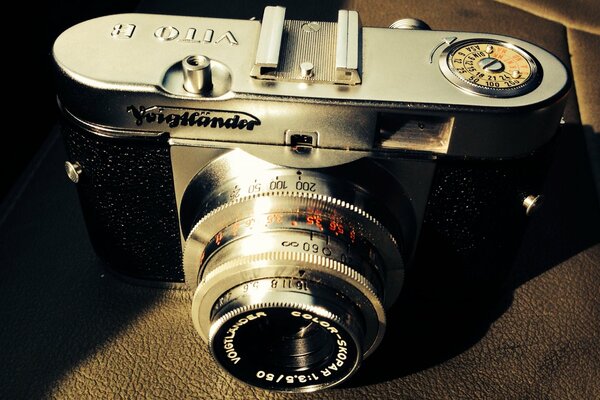 A silver-colored camera on a dark background