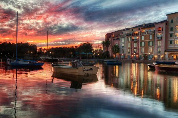 A house with glowing windows in the evening on the lake
