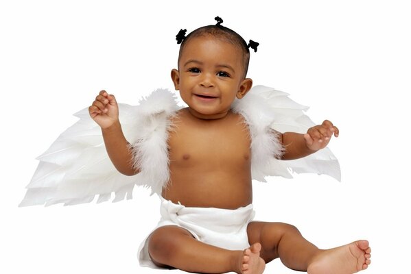 The swarthy little angel smiles with his arms outstretched