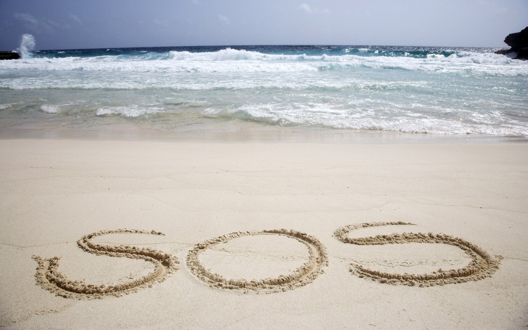 the symbol on assistance letters in the sand sos foam water shore sea surf beach sand the inscription horizon the sky summer nature landscape