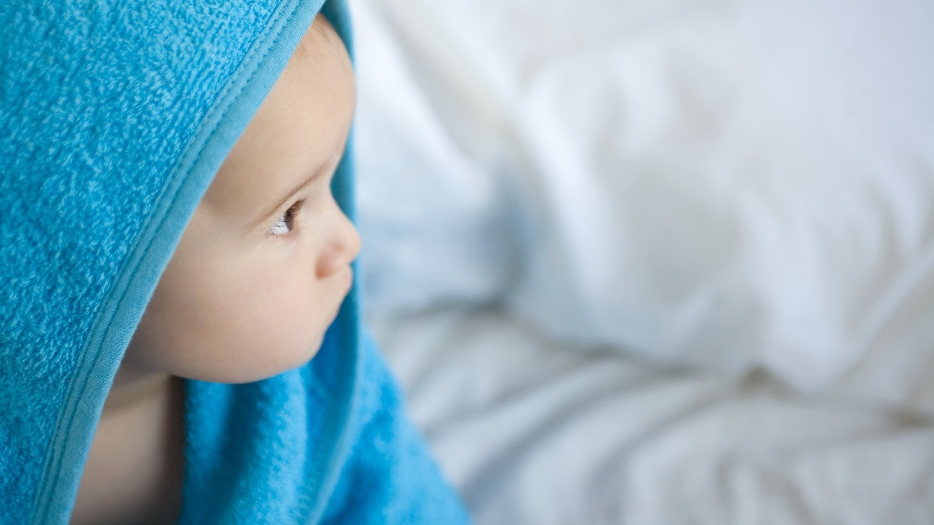 observant kinder blue towel after bathing observation snub nose portrait look eyes baby baby baby profile