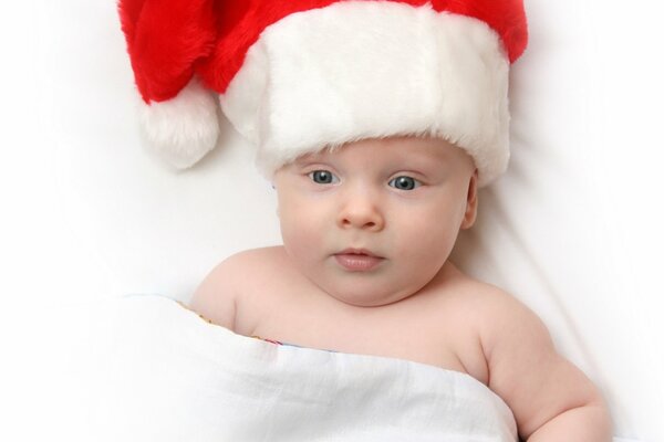 A small child in a Santa Claus hat