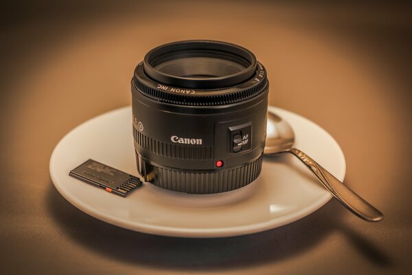 Canon lens is black on a saucer