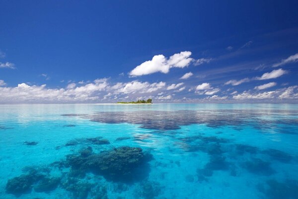 Blue sea, somewhere in the distance a green island is visible