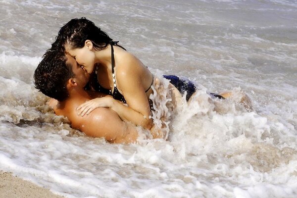 Romantic kiss in the sea spray