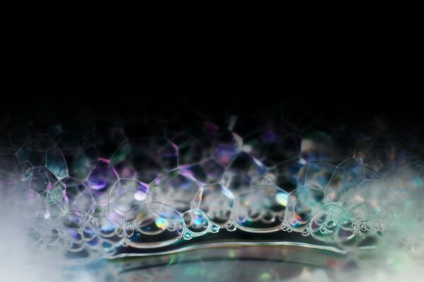 Macro shot of soap bubbles. The color spectrum in bubbles. Foggy snapshot