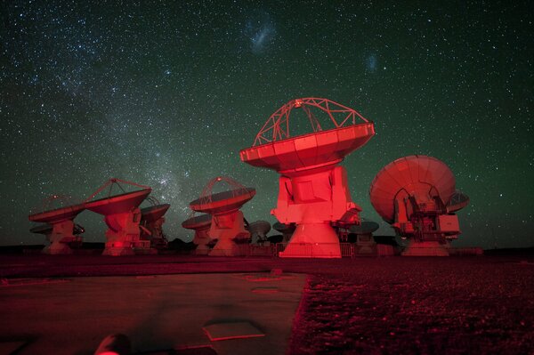 Radio telescopes and antennas on the background of the starry sky