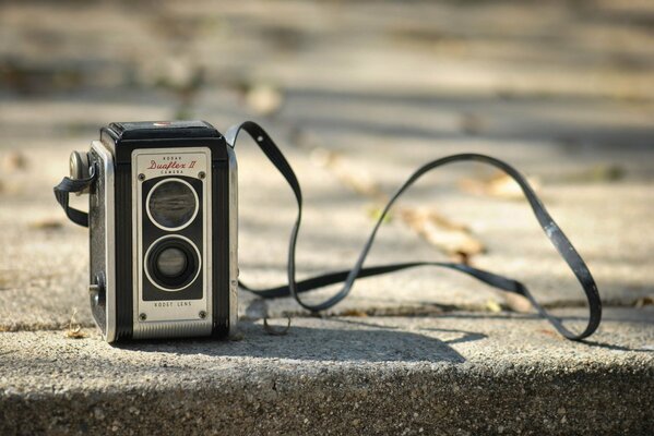 Retro camera image on asphalt background