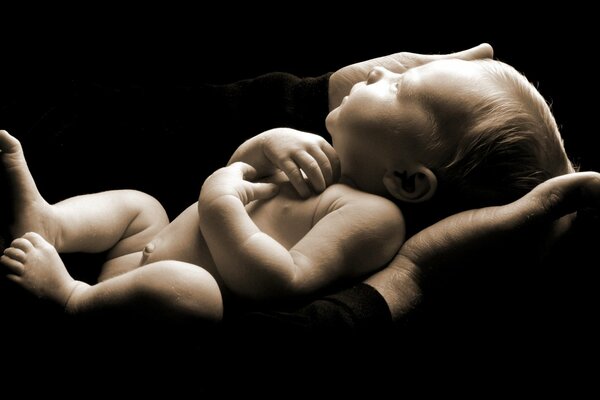 Newborn baby in dad s arms