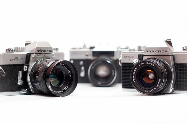 Three cameras are on a white background