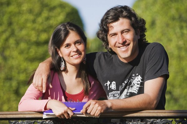 Couple hugs while standing on the bridge