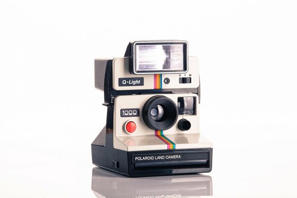 Automatic polaroid camera on white background