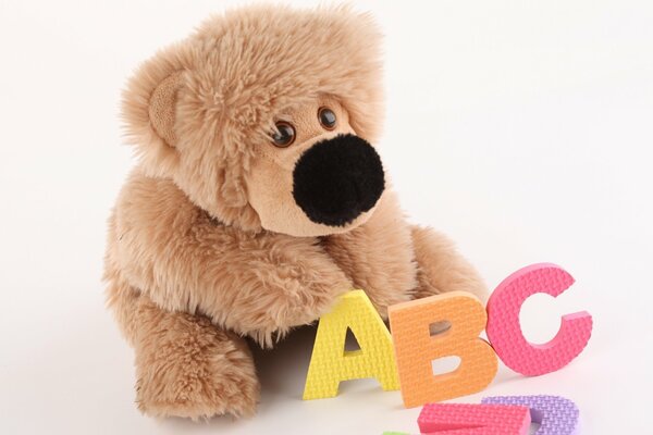 A stuffed toy with a big nose and an alphabet