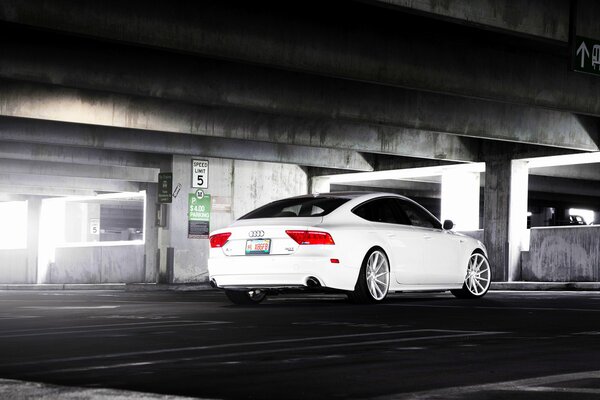 Concrete parking background for a white audi