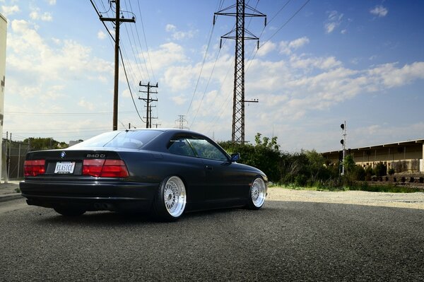 Black BMW on a blue sky background