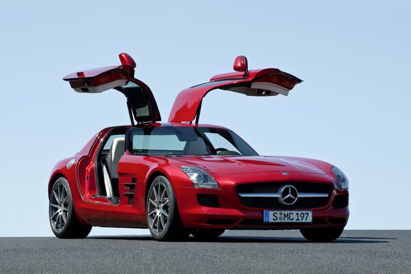 Red 2014 mercedes-benz sls 63 amg c197 with upward-rising doors