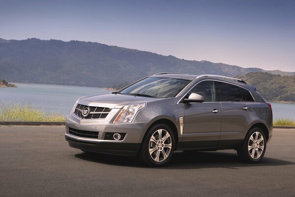 Cadillac srx SUV gris sur fond de montagnes