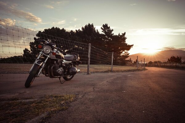 Parked suzuki motorcycle on the background of sunset