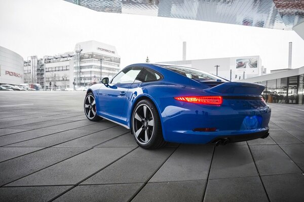 Un Porsche 911 azul se encuentra cerca de la cabina del Diller