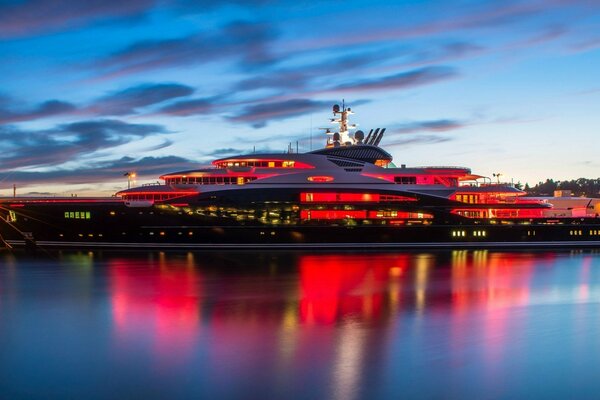 Mega yacht with colorful reflection in the water