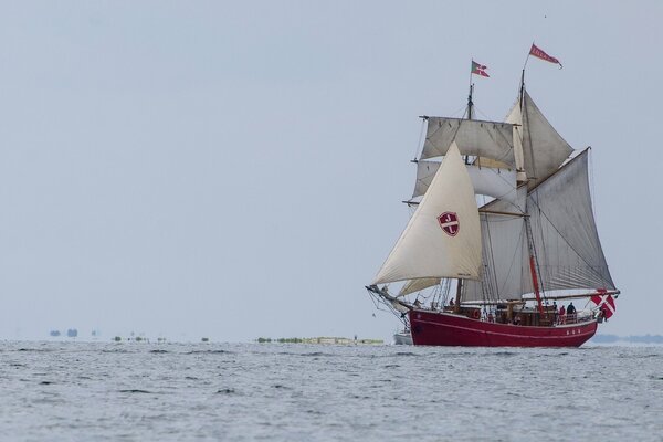 A large ship with sails is sailing on the sea