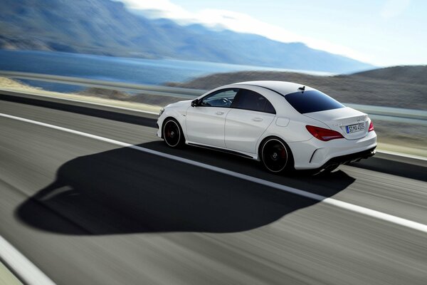 White Mercedes at speed in the mountains