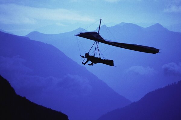 PLANNING AN AIRPLANE IN THE DARK OVER THE MOUNTAINS