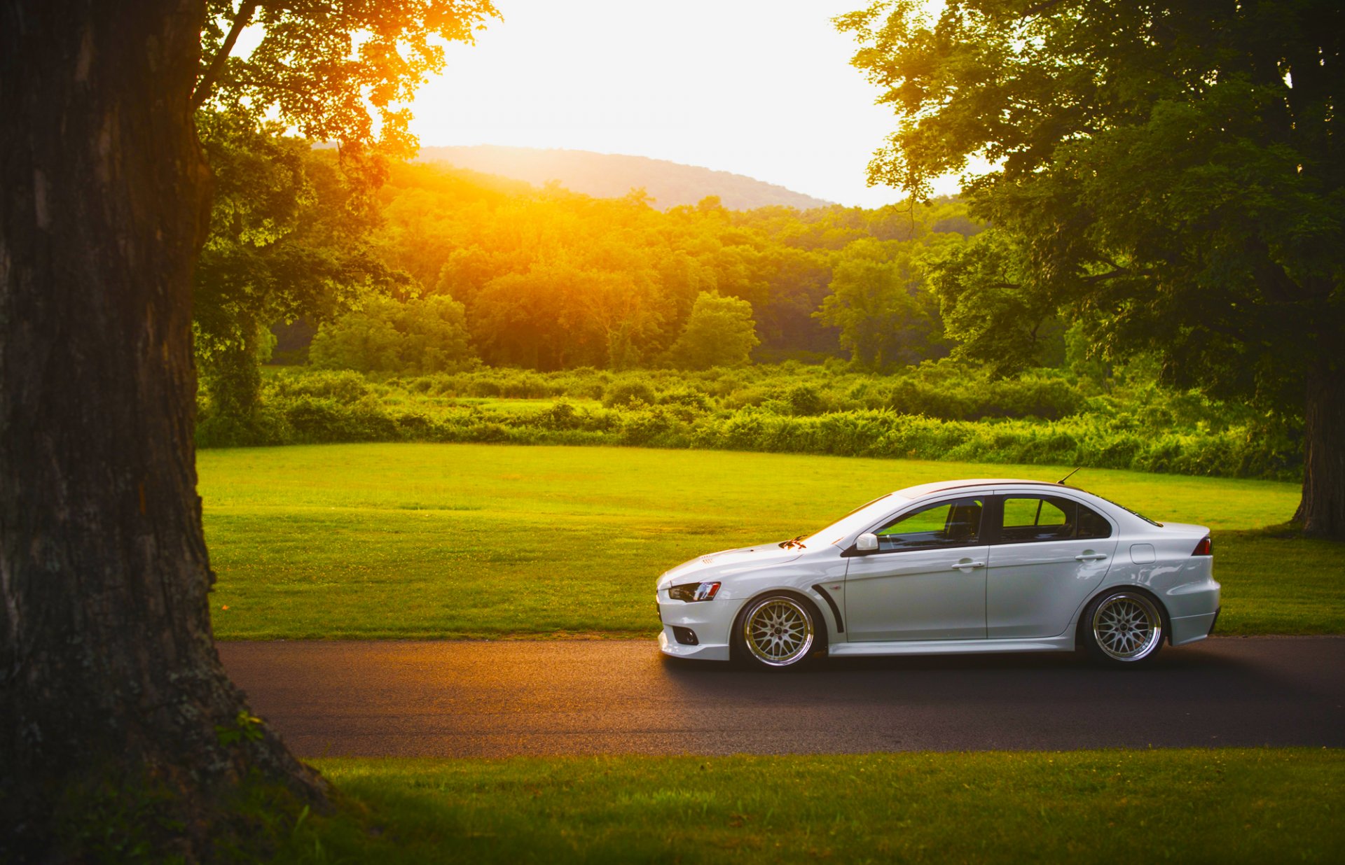 mitsubishi lancer evolution x white stance car side sunset sun grass road