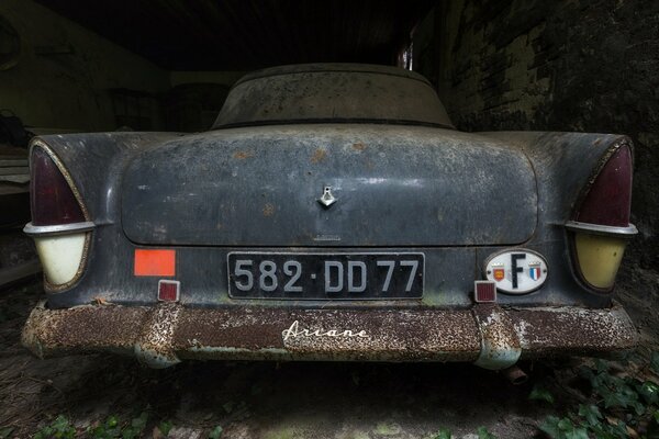 The car is going under the scrap, despite the background