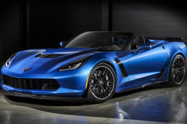 A blue supercar on a dark background