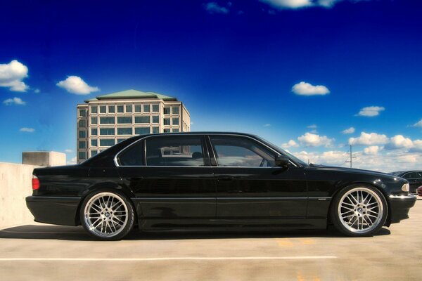 A black car against a blue sky