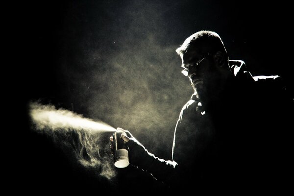 Black and white photo of a man with a can of paint